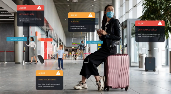 Image of a woman in an airport, sitting on her luggage